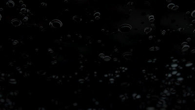 transparent water droplets on a black background