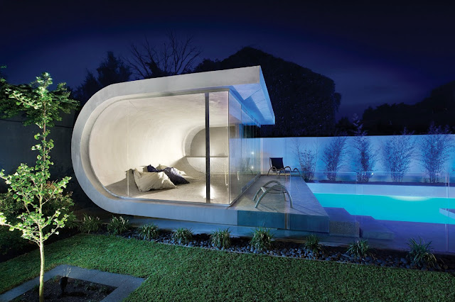 Modern pool house by the pool at night 