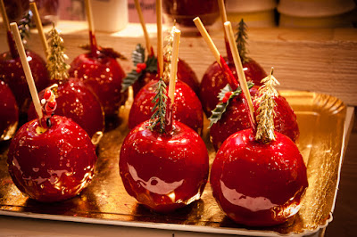 Festive, red, candied apples on a tray.