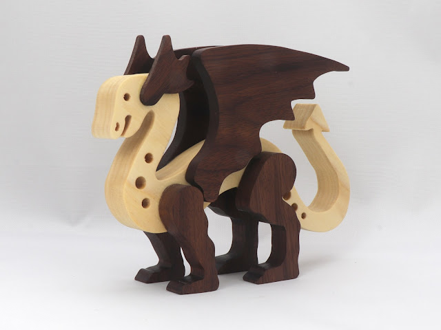 Handmade wood dragon figurine made from premium contrasting color hardwoods and hand finished with a custom blend of oils and waxes applied hot for deep penetration durability, the perfect gift for any dragon lover.