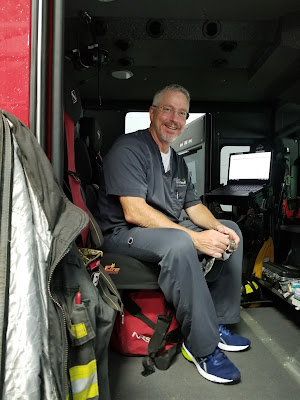 Dr. Kitzmiller sitting in a fire truck.