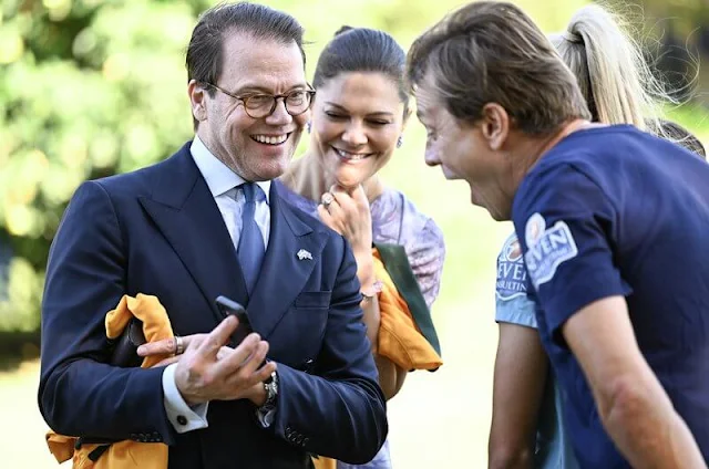 Crown Princess Victoria wore a belted short sleeve blazer by Sandro, and a bespoke purple floral print dress