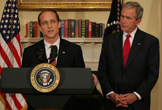 President George W. Bush listens as Steve Preston