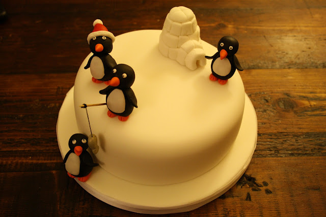 Christmas cake decorated with model Penguins