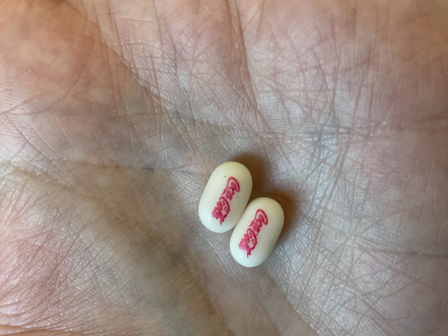 Very close up of the tictacs with coke logo printed on them