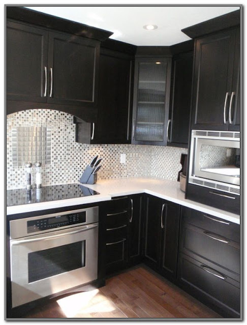 black kitchen cabinets with white quartz countertops