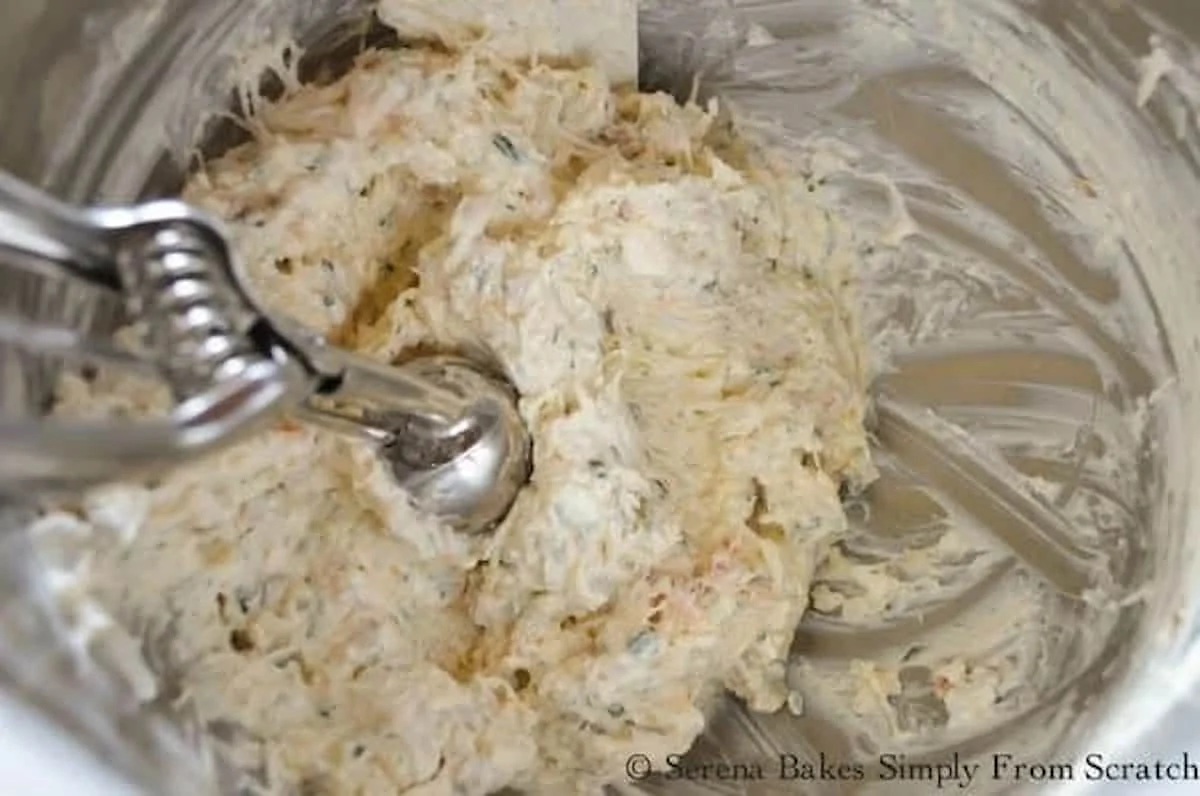 Gourmet Cream Cheese Dungness Crab Filling in a stainless steel bowl with a cookie scoop.