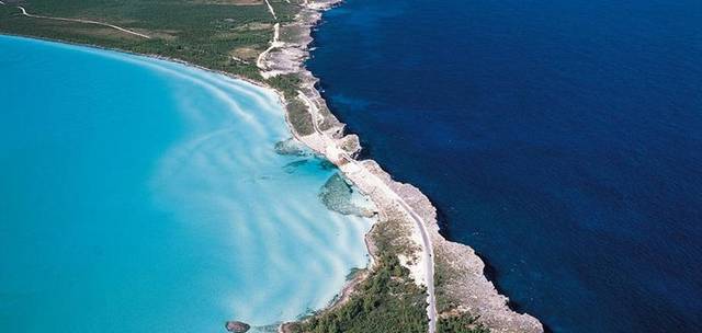 Eleuthera is one of several islands that lies within the archipelago in The Bahamas, about 80 km east of the capital city Nassau. It is long – about 180 km – and thin - only about 1.6 km wide in places. The light blue waters of the shallow Caribbean Sea on one side of the island stand out in stark contrast to the deep blue of the Atlantic Ocean thousands of feet in depth. One of the best places to see this extraordinary juxtaposition is at the Glass Window Bridge.