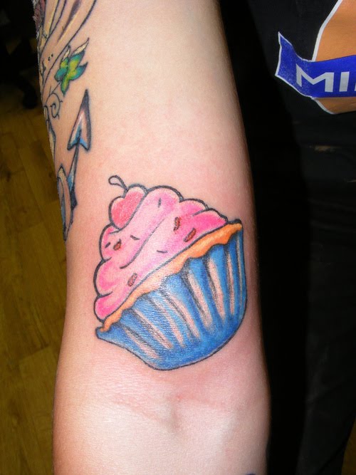 Cupcake arm tattoo for girls.