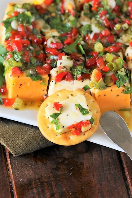 Slice of Marinated Cheese On a Cracker Image