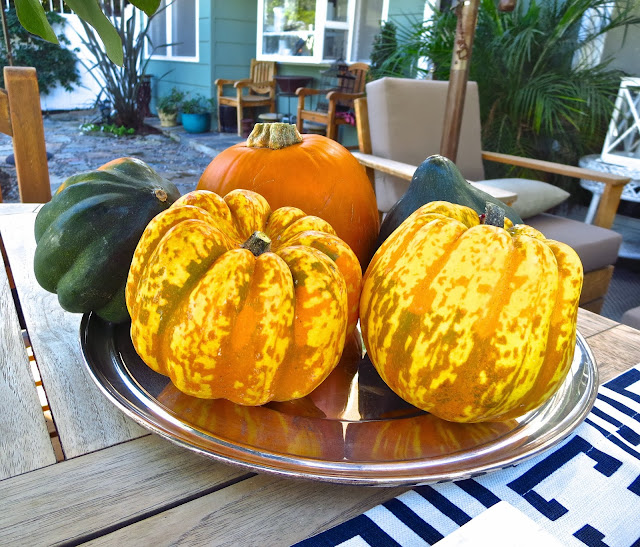 Winter squash on a silver charger at an casual outdoor fall tea 