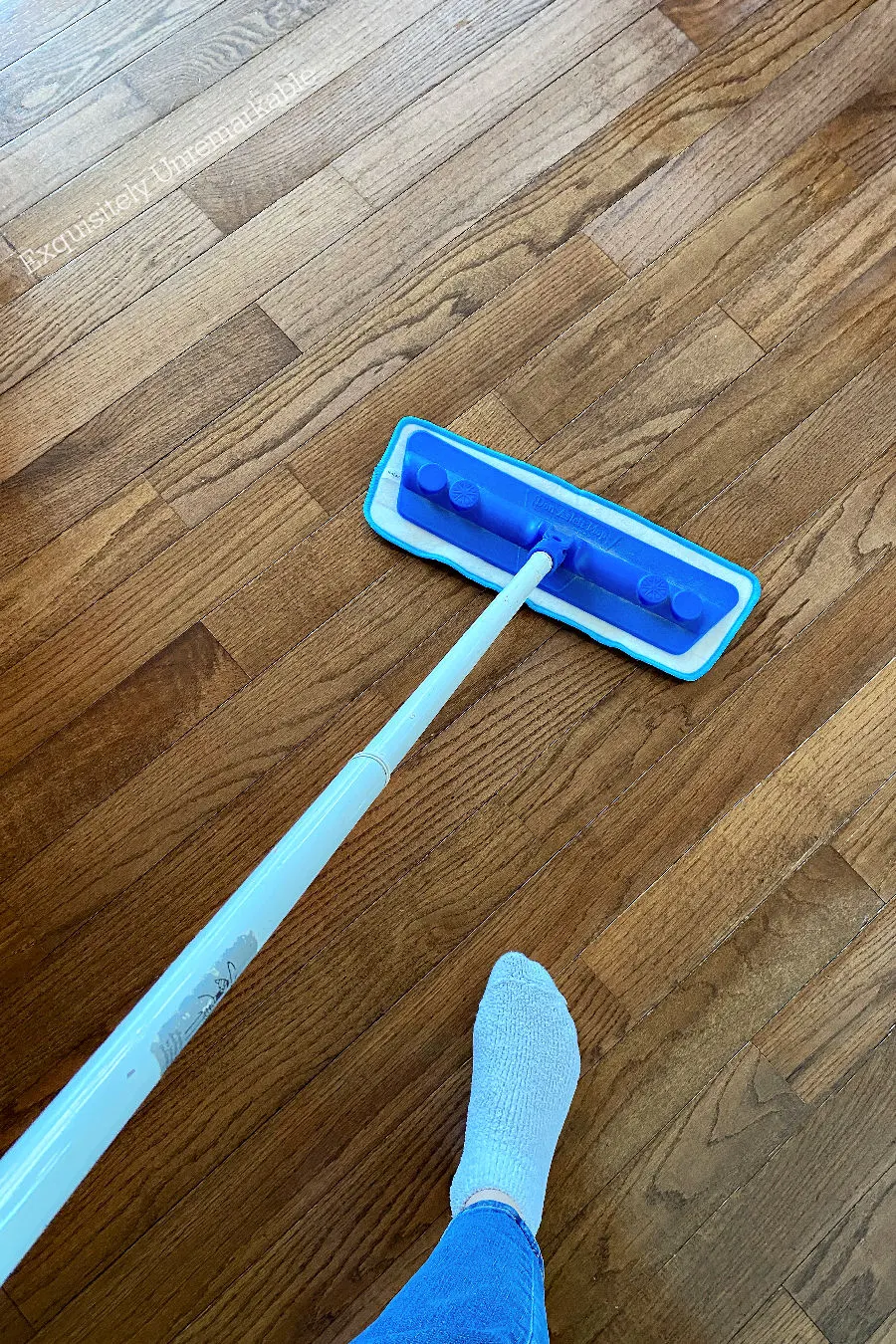 Mopping a wood floor with a microfiber cloth