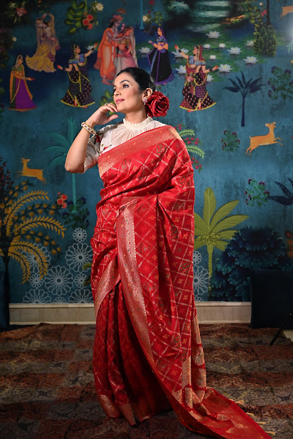 Red Banarasi saree which is inspired from gharchola and patola. It has bandhini work also.