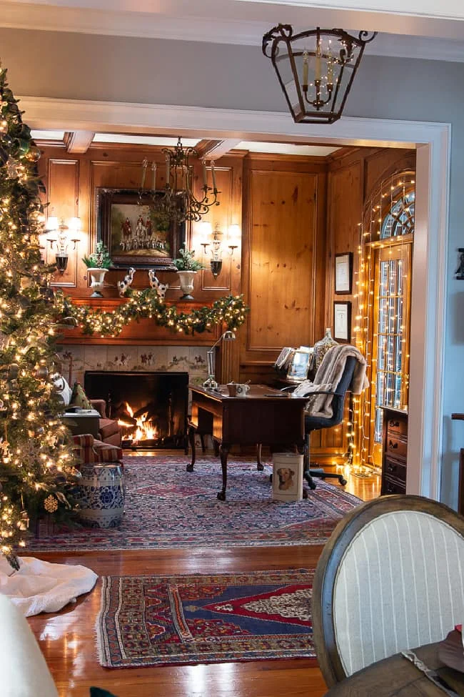 living room with Christmas tree, mantel garland, lights