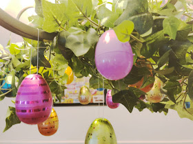 Take your Easter Egg hunt inside with this fun Easter decoration. It's so easy to decorate your dinning room chandelier with beautiful Easter eggs and greenery to make a stunning Easter Egg Chandelier that will bring some extra sparkle and shine to your Easter dinner.
