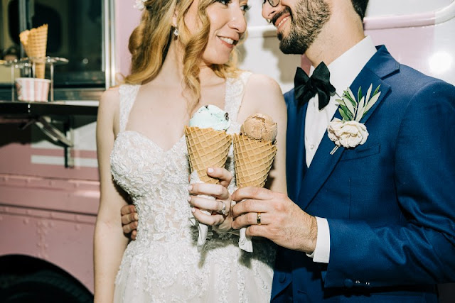 bride and groom cheers with ice cream cones