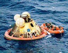 The three Apollo 11 crew men await pickup by a helicopter from the USS Hornet, prime recovery ship for the historic Apollo 11 lunar landing mission