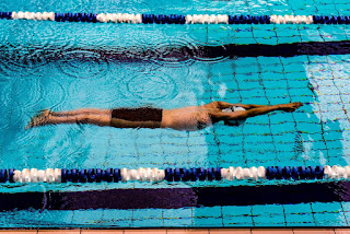 Image of a swimmer doing torpedo in the pool swimming lane. Sometime you need the right swimming equipment to help 