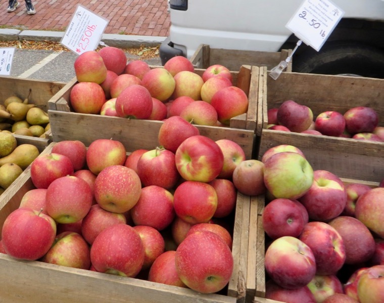 Extraordinarily beautiful orange and yellow Jonagold apples in 2 wooden bins.