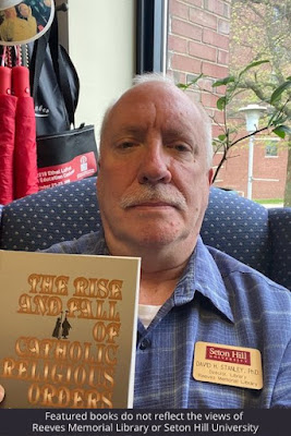 Dr. Stanley with his copy of The Rise and Fall of Catholic Religious Orders by Patricia Wittberg