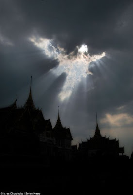 Angel in the clouds above Thai Buddhist temple