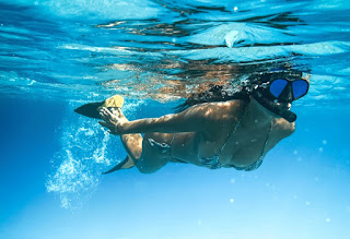 girl snorkeling in water