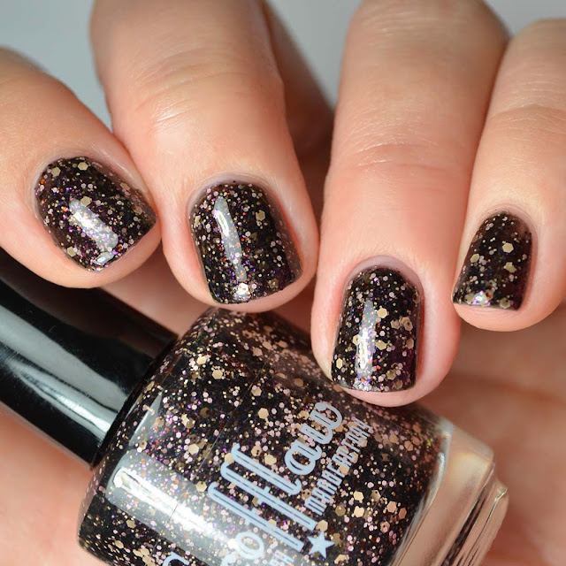 black nail polish with peach and pink glitter swatch