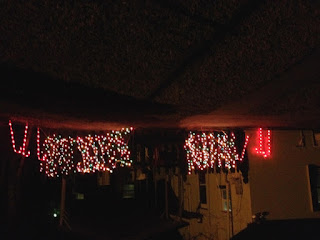 Christmas lights on the fence outside Laurel's house