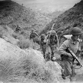 Members of the 10th Battalion, Royal Berkshire Regiment climbing the heights of Calvi Risorta in the invasion of Italy, October 1943.