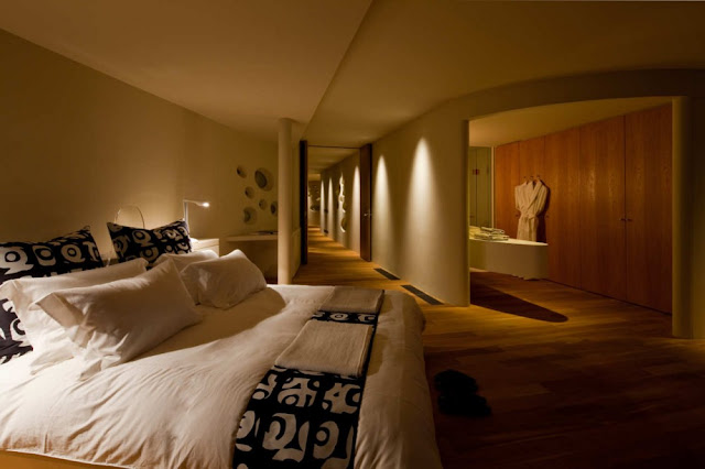 Photo of master bedroom and hallway in the background inside of circular home