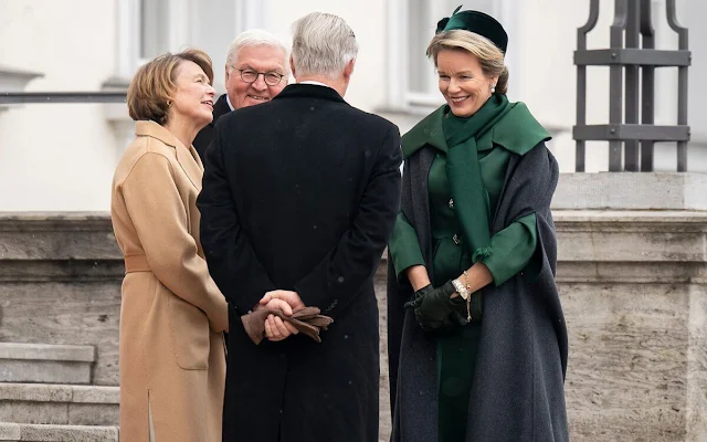 Queen Mathilde wore a camel embroidered coat by Esmeralda Ammoun, and green silk satin dress coat by Natan