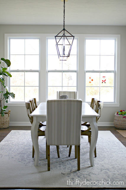 upholstered chairs with rug at end of table