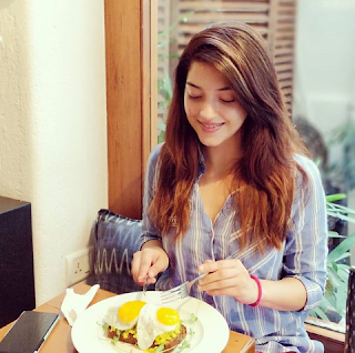 Mehreen Pirzada with Cute Smile for Eating Food