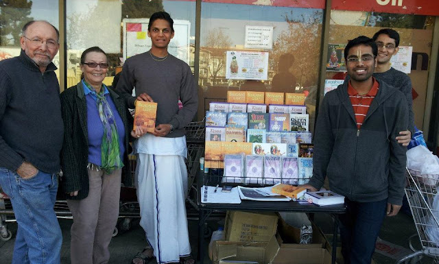 Sankarshan Das Adhikari - Devotees Ecstatically Distribute Books from a Book Table