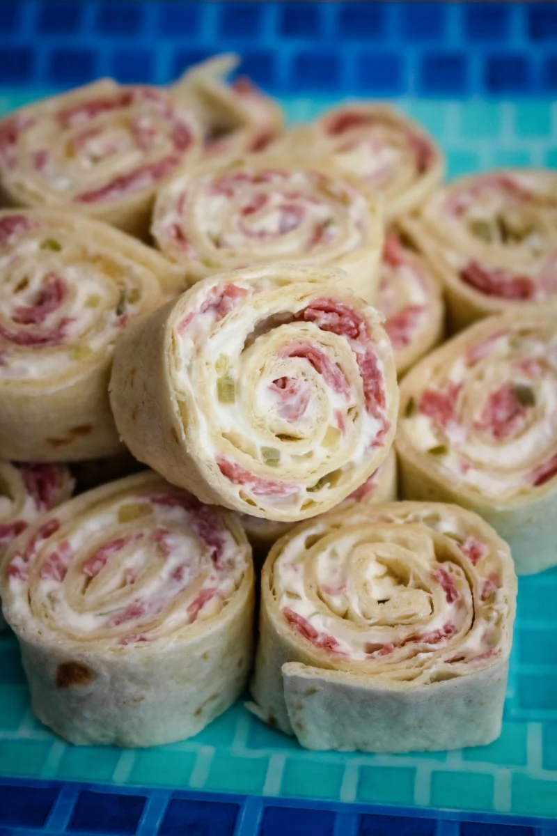 Salami Pinwheels are easy to make with just four simple ingredients! They make a fun and tasty snack, lunch, or party food. #salami #appetizer #fingerfood