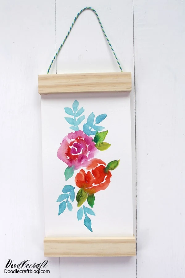 Make a hanging scroll from recycled materials. This elegant and simple painted floral scroll makes a great gift or gorgeous home decor. This great scroll-like technique works for any type of art--including the kids doodles.