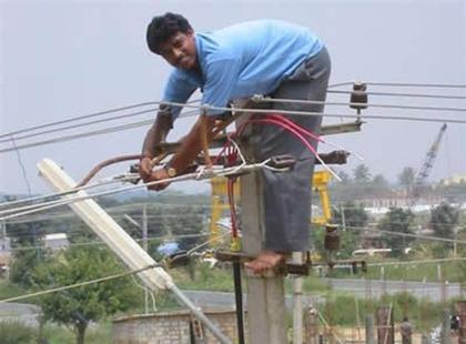 Man works on electric cables