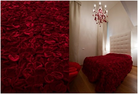 White bedroom with bedspread made of red rose petals
