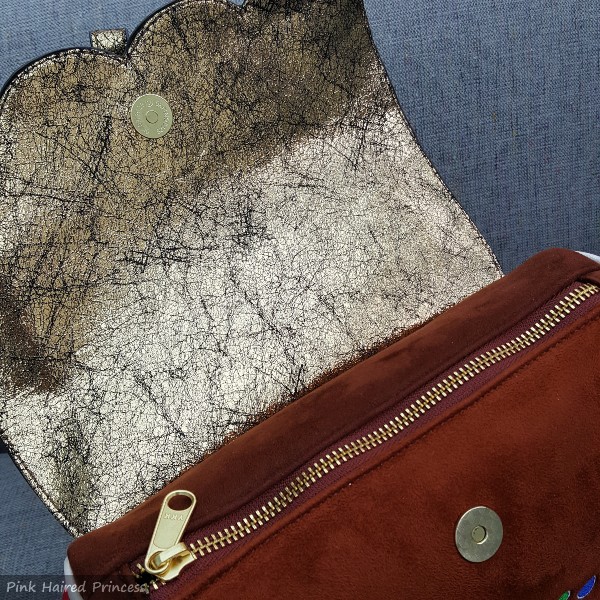 metallic flap lining, zip top handbag close up