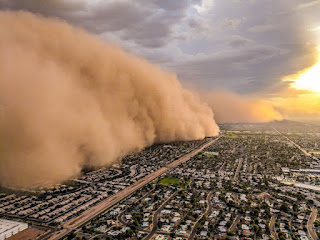 Aerial view of a giant dust cloud bearing down on housing tracts. Photo by Jason Ferguson