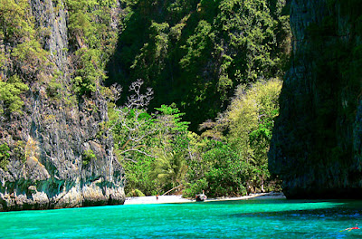 with the longtail boat at a Phi Phi Island beach