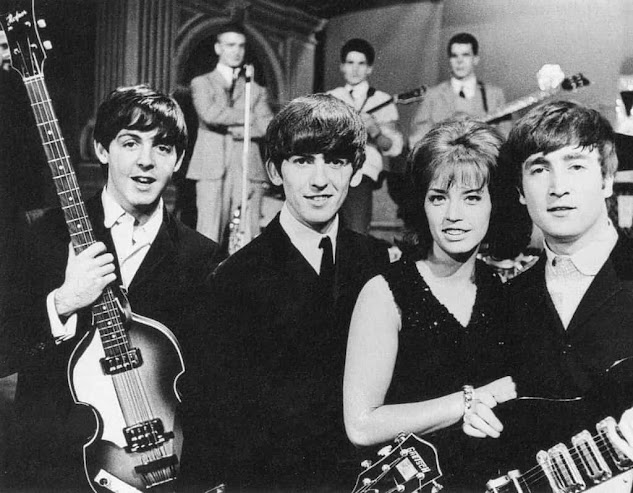 On the 30th of October in 1963, the set of the Swedish television show "Drop-In" saw the presence of McCartney (Farthest-left), Harrison (second-left), Lennon (Farthest right), and Swedish pop singer Lill-Babs (second-right).