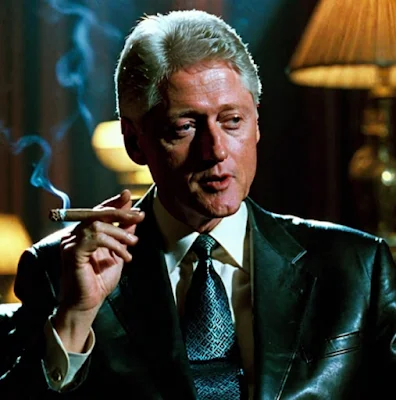 Bill Clinton smoking a cigar wearing a black leather blazer from the chest up