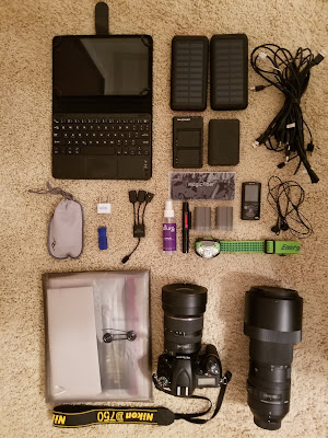 Laptop, binoculars, Nikon camera and solar chargers for thru hiking