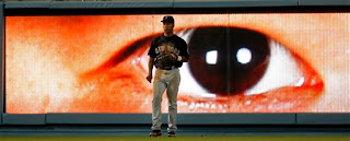 Big eyes on the wall at Dodger Stadium stare at Moises Alou