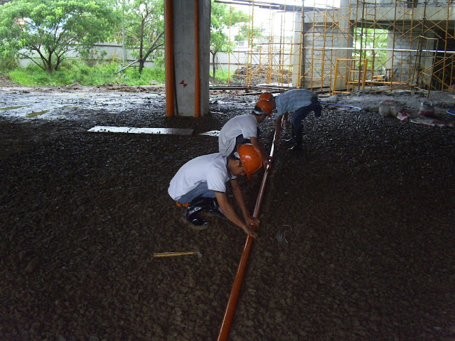 workers aligning the pvc pipe cover