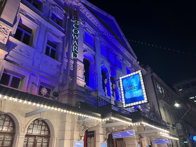 The outside of noel coward theatre london at night