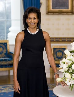 Michelle Obama wearing double standed pearl necklace and black shift dress