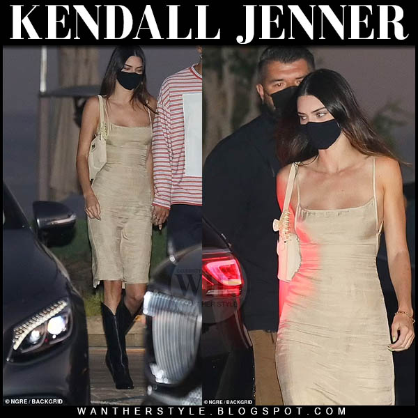Kendall Jenner in beige dress, black boots with beige shoulder bag