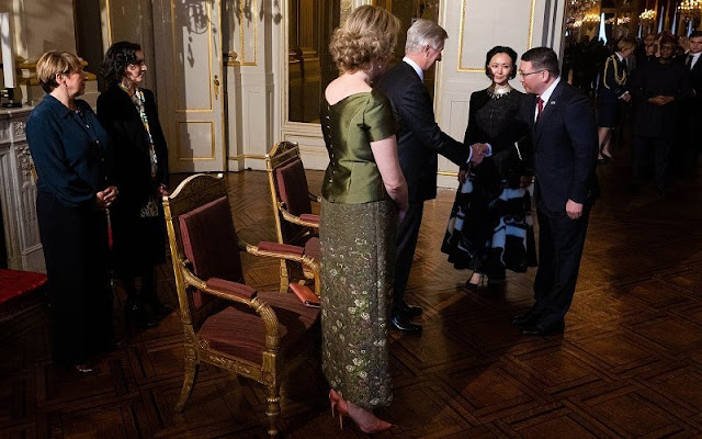 Queen Mathilde wore a green half sleeve silk satin blouse by Natan, and a green embroidered midi skirt by Natan